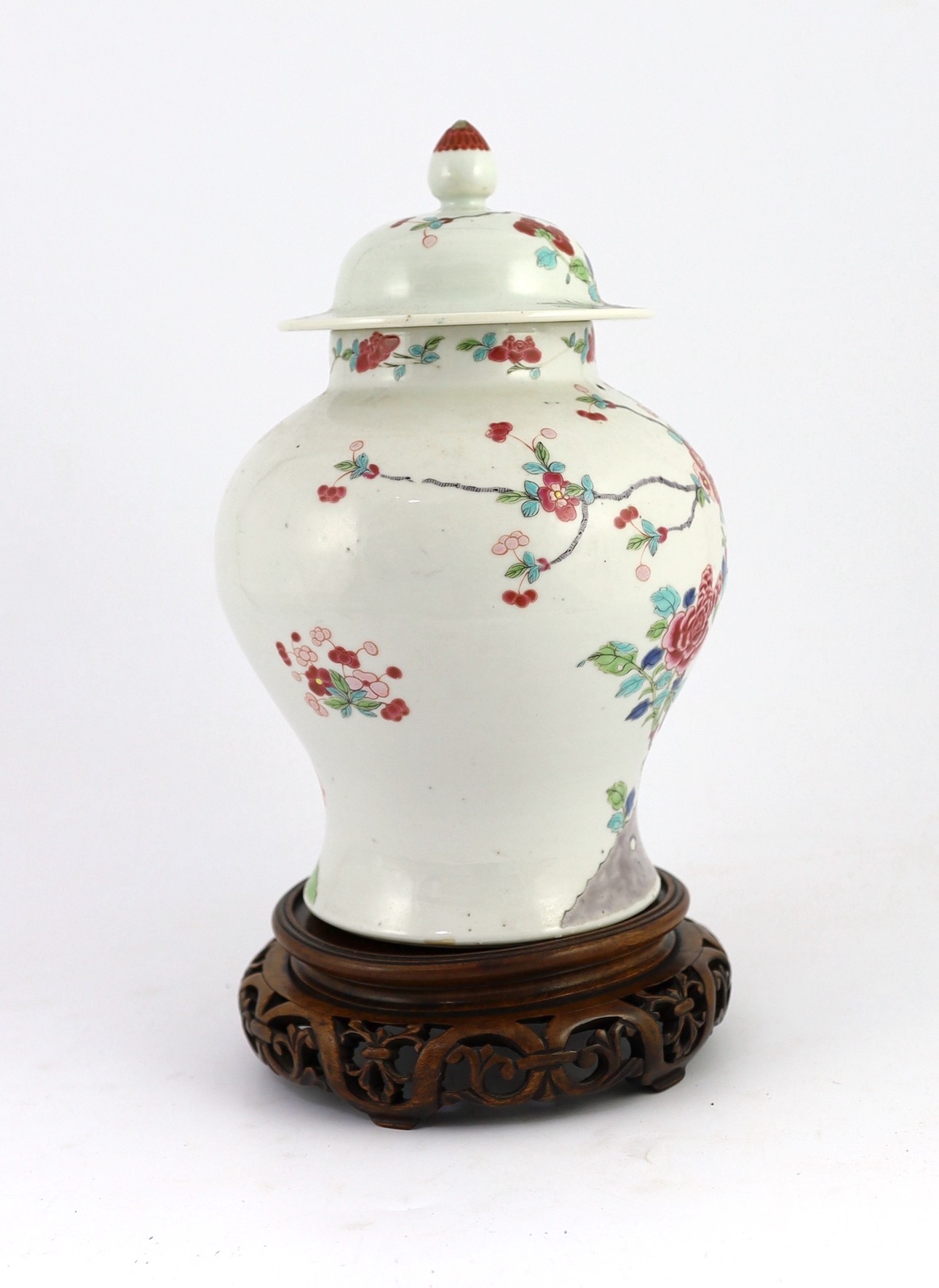 A Chinese famille rose fencai 'pheasant' vase and cover, 19th century, Jiaqing-Daoguang period, 28cm high, small faults to cover, wood stand